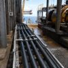 nek 606 bfou p105 cable offshore application Fixed black offshore cables installed on a cable tray in an oil and gas platform environment