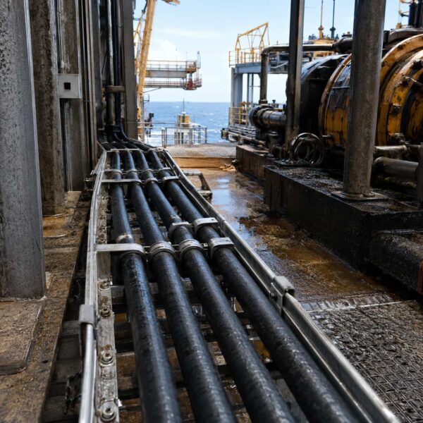 nek 606 bfou p105 cable offshore application Fixed black offshore cables installed on a cable tray in an oil and gas platform environment