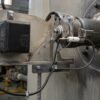 image Industrial gas burner with high voltage igniter wires running from the ignition transformer to a ceramic-insulated spark rod at the burner throat