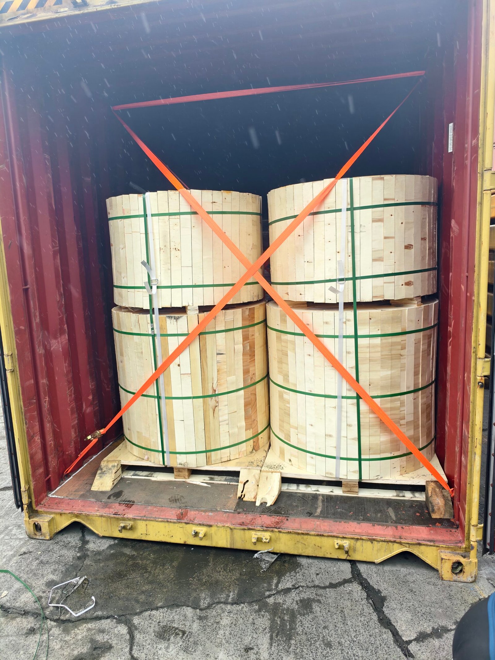 Cable drums secured inside a shipping container for export delivery
