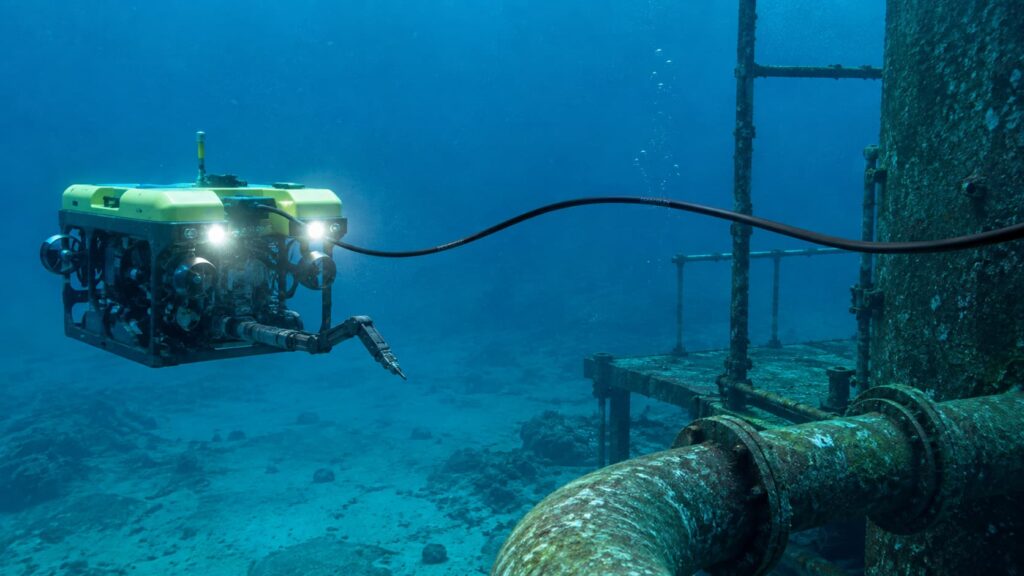 Neutrally buoyant ROV tether cable connecting an underwater inspection vehicle near subsea piping