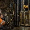 Underground mine hoist cage and operator scene illustrating suspended NTMTWOEU mine hoist cable application