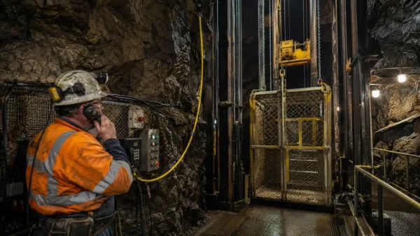 Underground mine hoist cage and operator scene illustrating suspended NTMTWOEU mine hoist cable application