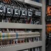 ul-xlpe-xlpo-hook-up-wire-application Control cabinet interior with contactors on the upper rail and a long terminal block row wired in coloured ferruled single cores, with orange power cables at the side