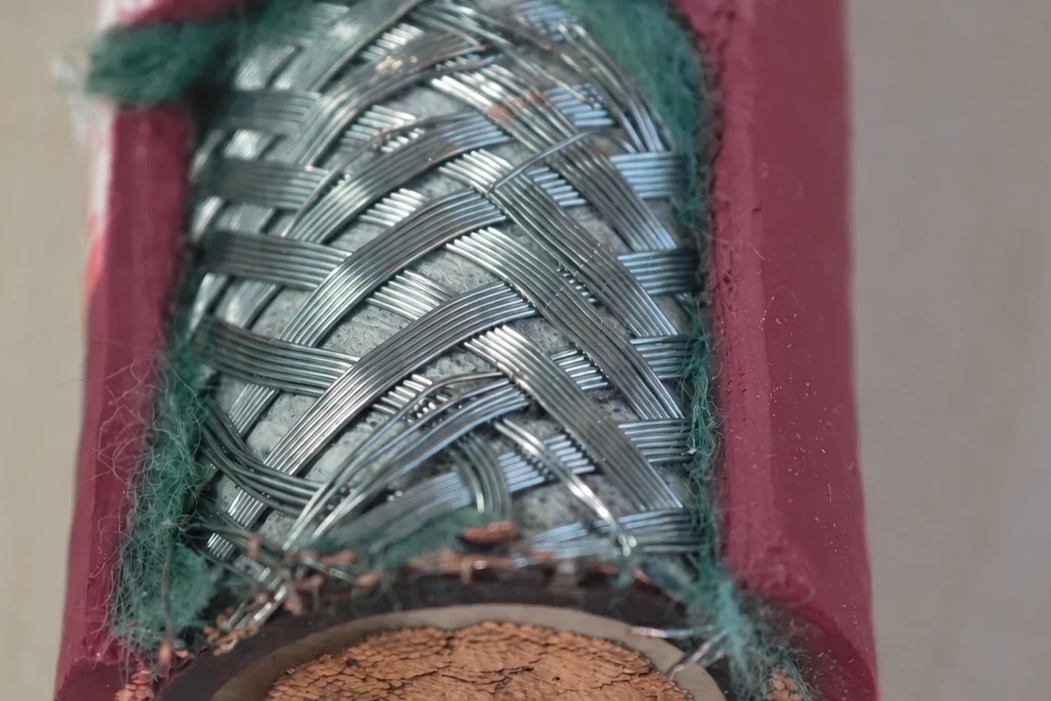 Close-up of a tinned copper braided shield showing the carriers, the crossing points and the small open windows between them
