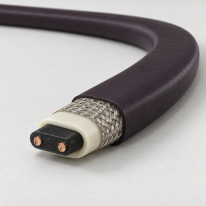 Steam-cleanable self-regulating heat trace cable with fluoropolymer outer jacket