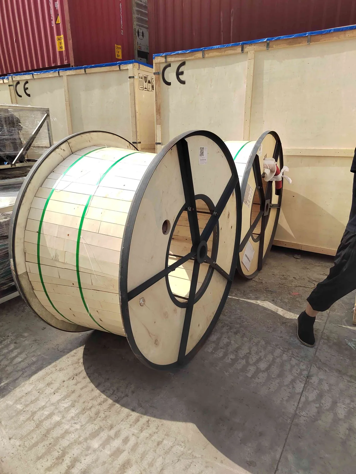 Wrapped reeling cable drums loaded into a shipping container