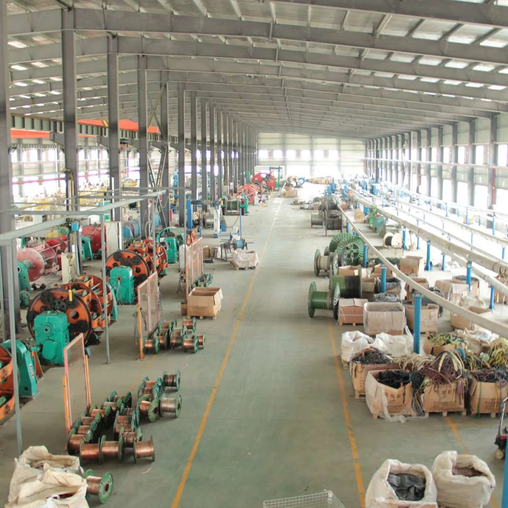 TEBAOFLEX cable workshop with production equipment, reels and a central aisle