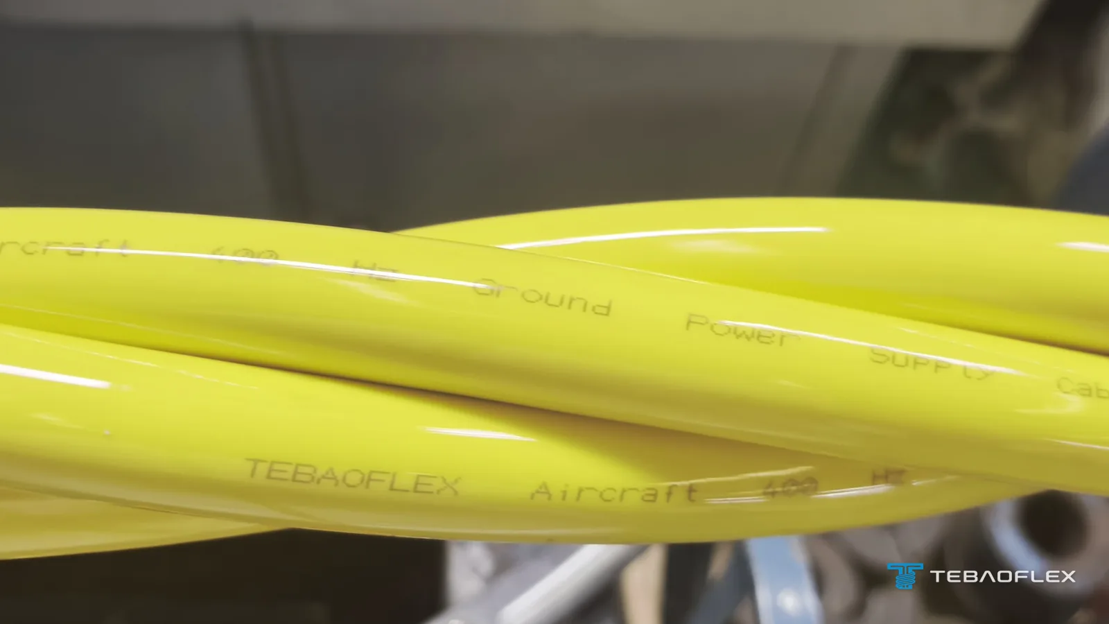 Four yellow PUR-sheathed cores of the 400 Hz ground power cable twisted together, printed TEBAOFLEX Aircraft 400 Hz Ground Power Supply
