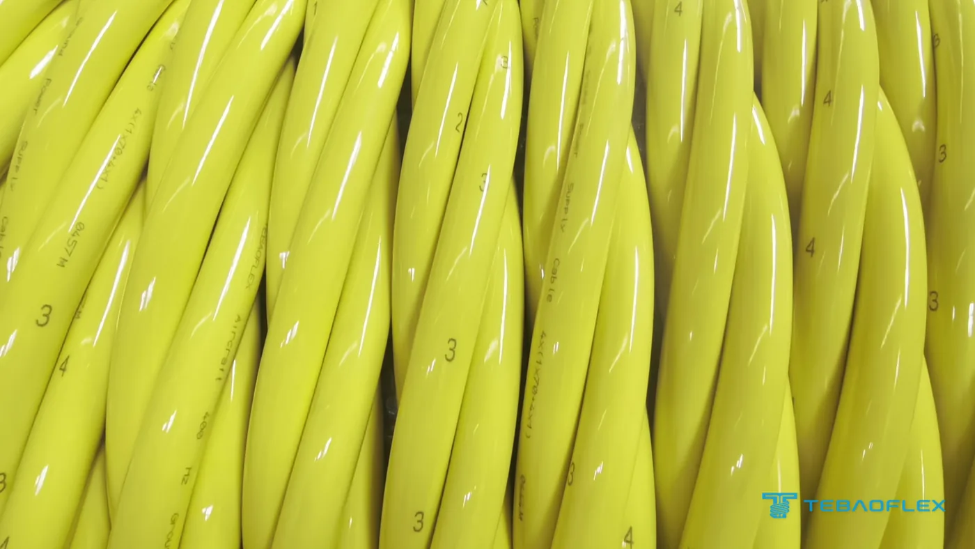 Layers of the finished cable on the drum: four twisted yellow cores with their numbers 1 to 4 and the TEBAOFLEX sheath print