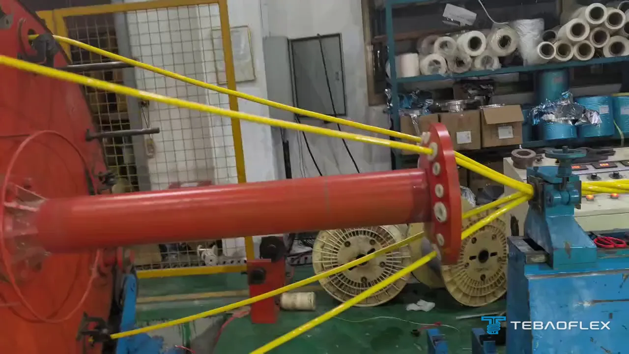 Four yellow PUR-sheathed cores leaving the lay-up machine and converging at the closing die, where they are twisted into one cable