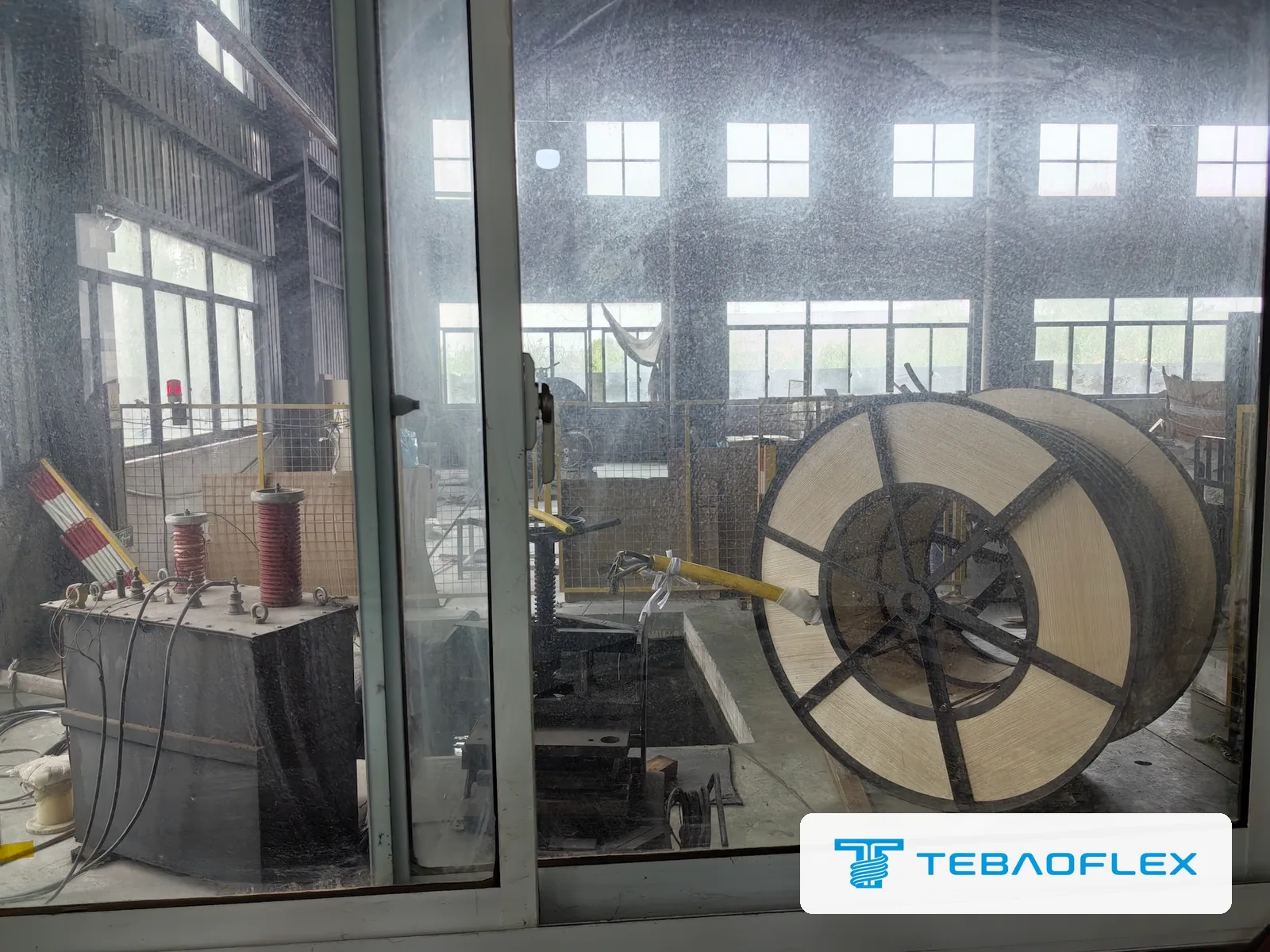 Finished drum of (N)SHTÖU-J in the fenced high-voltage test bay with the test transformer