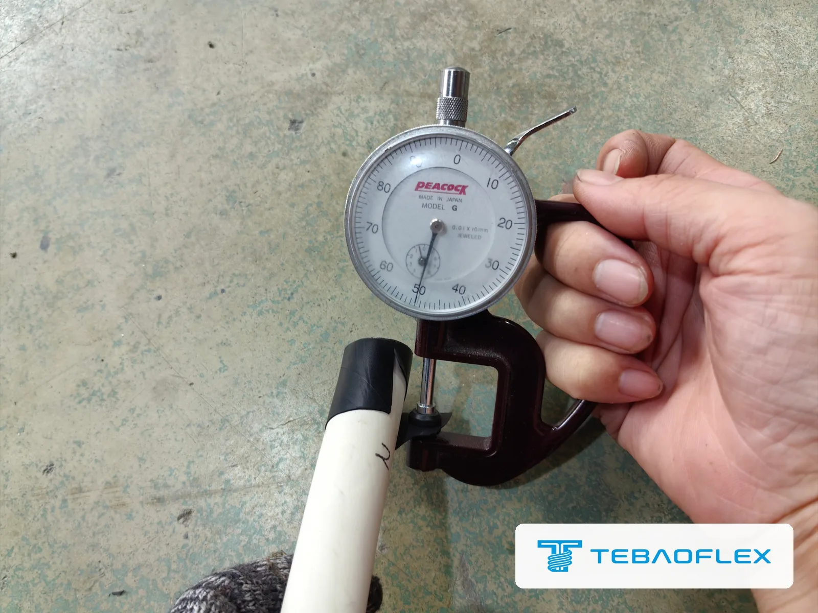 Dial thickness gauge on the insulation screen of a core, reading 0.50 mm