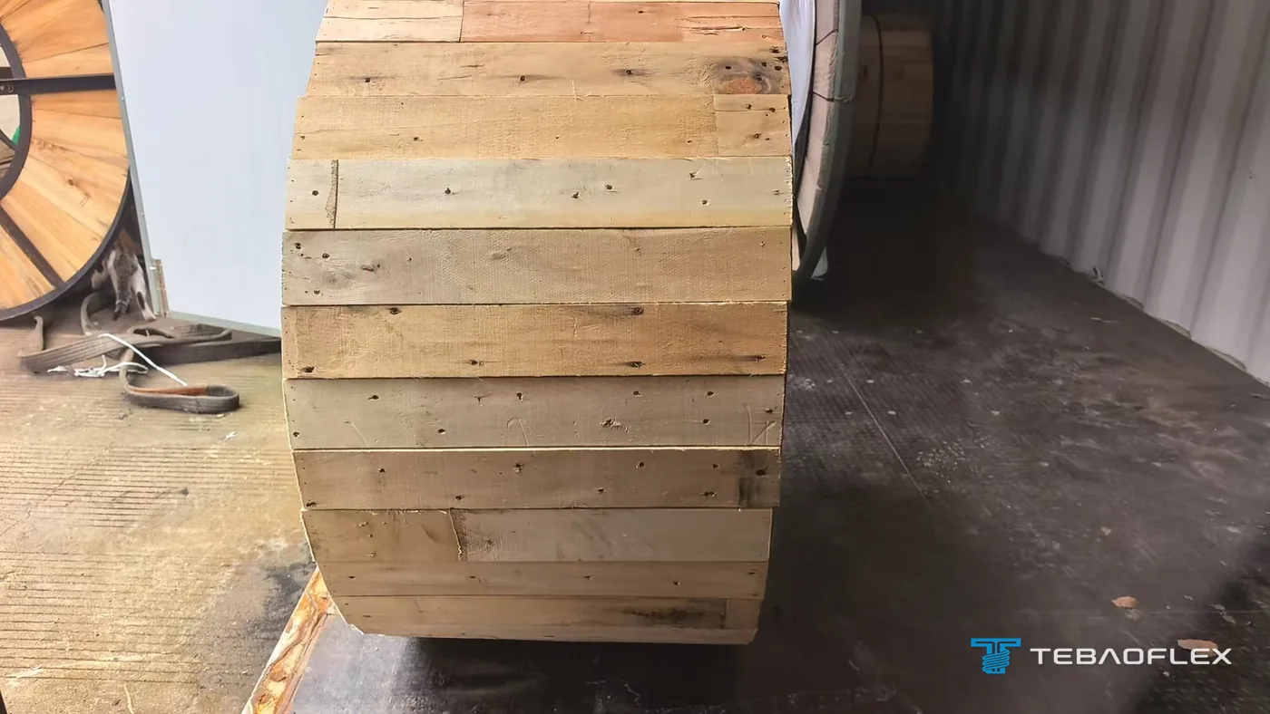 Cable drum closed with wooden lagging boards being loaded into a shipping container