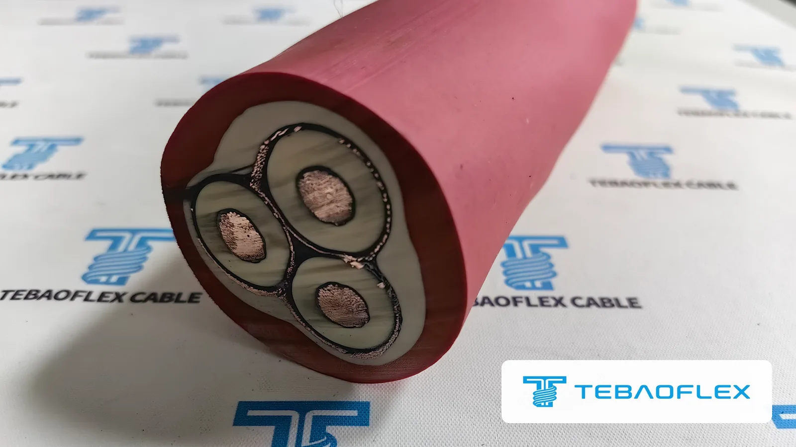 (N)TSCGECEWÖU 12/20 kV 3×35+3×25/3 reeling cable cut end: three screened EPR cores in a red rubber sheath
