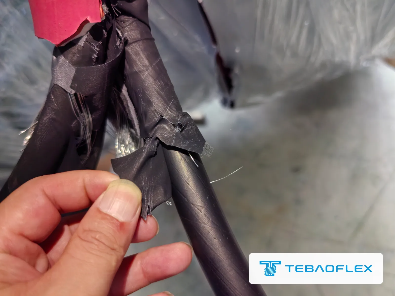 Semi-conductive tape over the tinned copper wire screen of a 12/20 kV core, peeled back