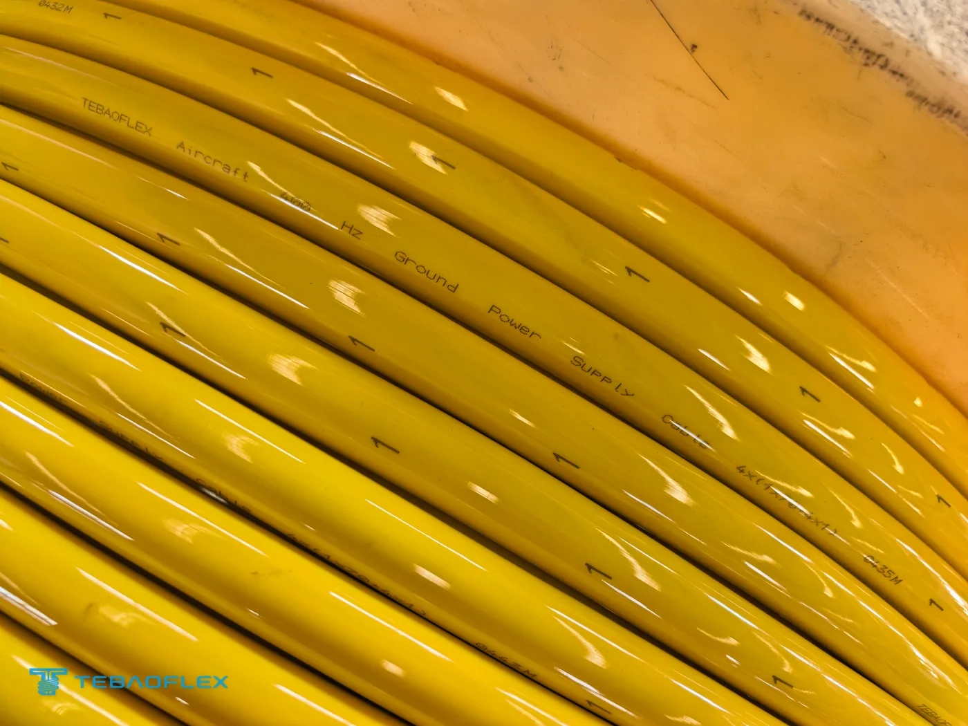 Yellow PUR-sheathed single cores on a drum before lay-up, printed TEBAOFLEX Aircraft 400 Hz Ground Power Supply Cable 4×(1×70+4×1) with metre marking and core number 1