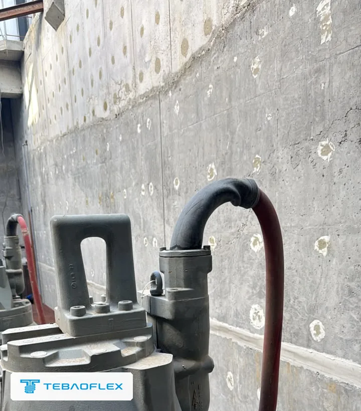 Top of the submersible pump in the pit: the existing red cable enters the motor housing through a rubber-sleeved cable entry